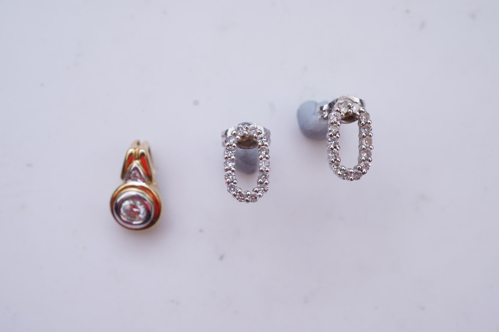 A diamond pendant and pair of diamond stud earrings